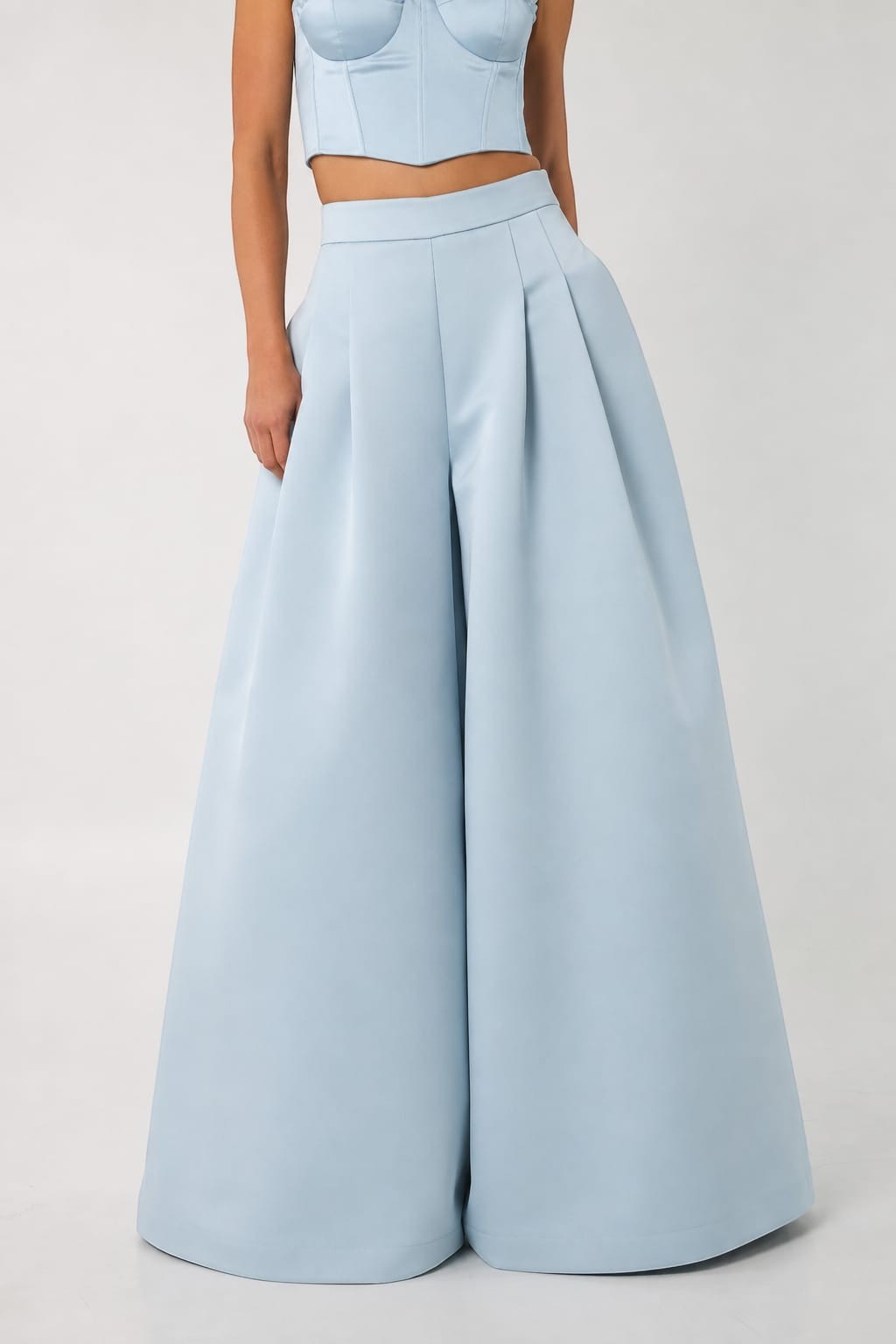 Mkeyzee London blue Duchess trousers featuring a high-waisted, wide-leg silhouette with elegant front pleats.