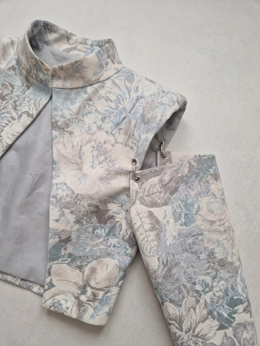 Mkeyzee London Thea cropped jacket in floral printed cotton with structured shoulders and detachable sleeve rings