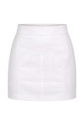 Mkeyzee London white high-waisted linen mini skirt with a structured silhouette and signature curved front seam piping.